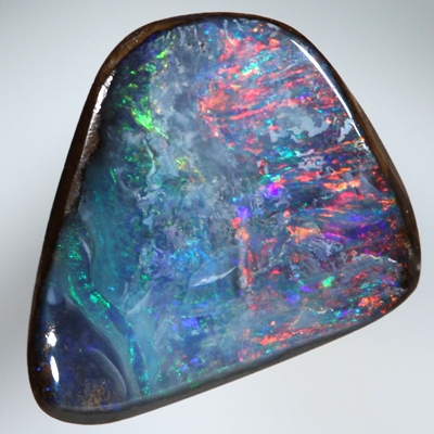 SOLID BOULDER OPAL Bright red sparkles over blue